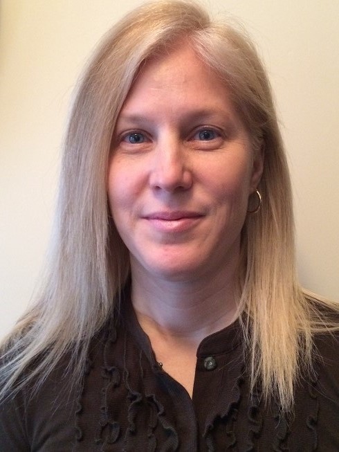 Author Sandra McTavish is a fair skinned woman with long, straight blonde hair and blue eyes. She smiles warmly at the viewer.